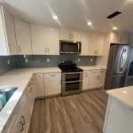 kitchen remodel blue backsplash and white cabinets