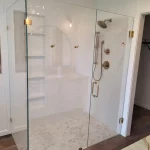 new shower door in white bathroom remodel