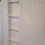 new shower shelves in white bathroom remodel