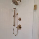 new shower handles in white bathroom remodel