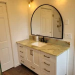 vanity area- curved mirror in bathroom remodel