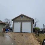 Construction of a two door garage grey sky